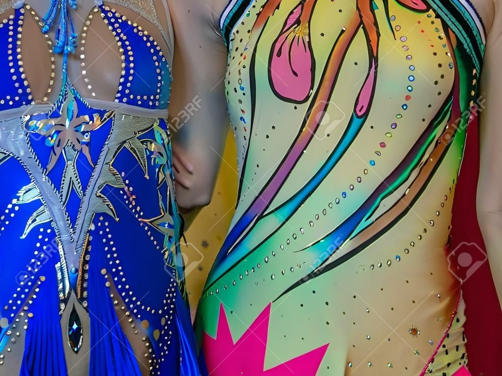 Background, texture. Colorful costumes of young girls exercise acrobatics