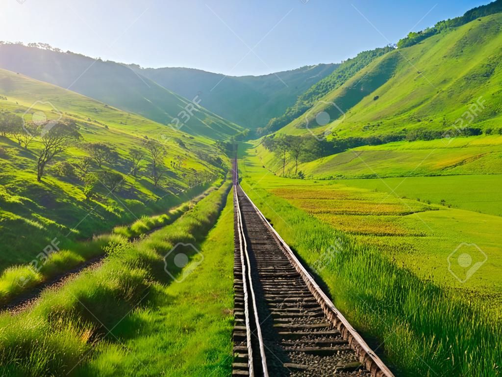 old railway track on the morning hills landscape 