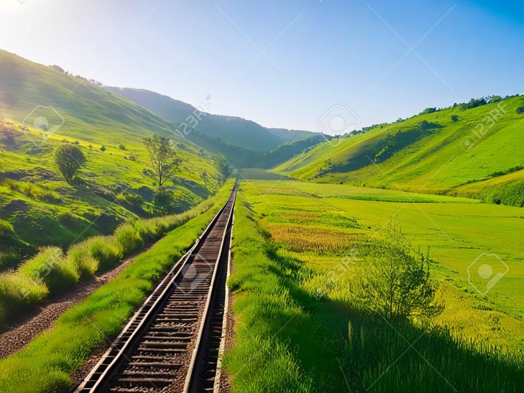 old railway track on the morning hills landscape 