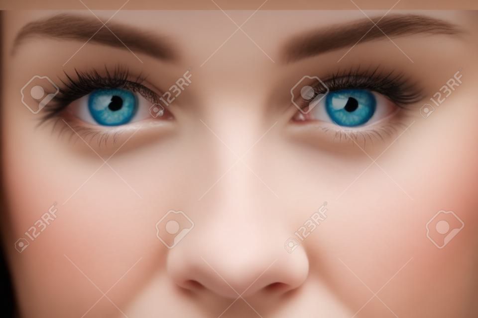 Detalle de la joven mujer rubia con ojos azules y nariz