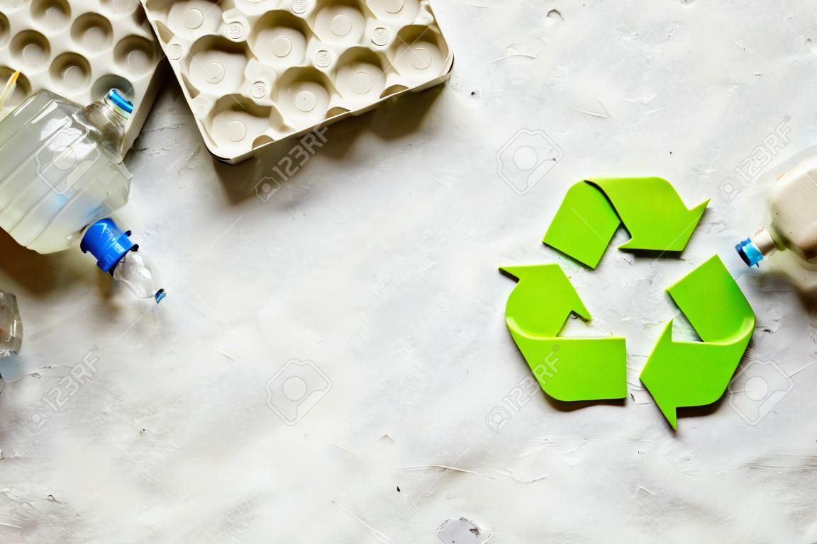 resíduos e símbolo de reciclagem no cuidado ecológico na vista superior de pedra