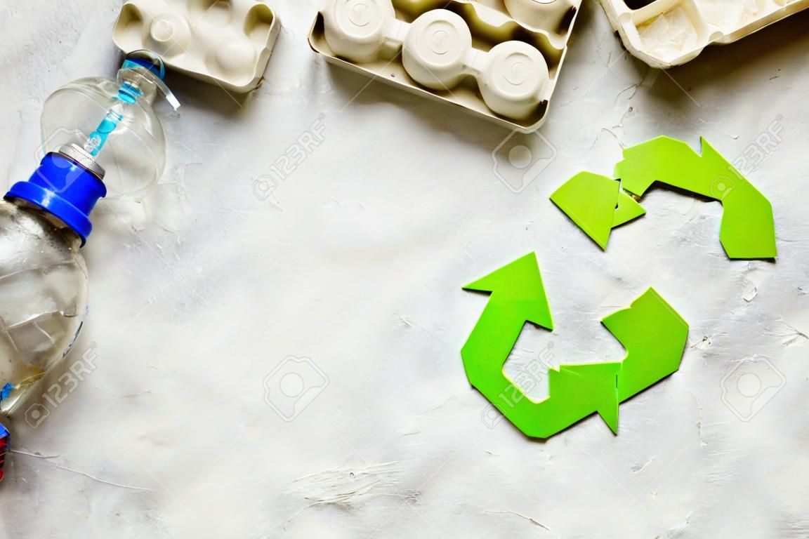 waste and recycling symbol in eco care on stone top view