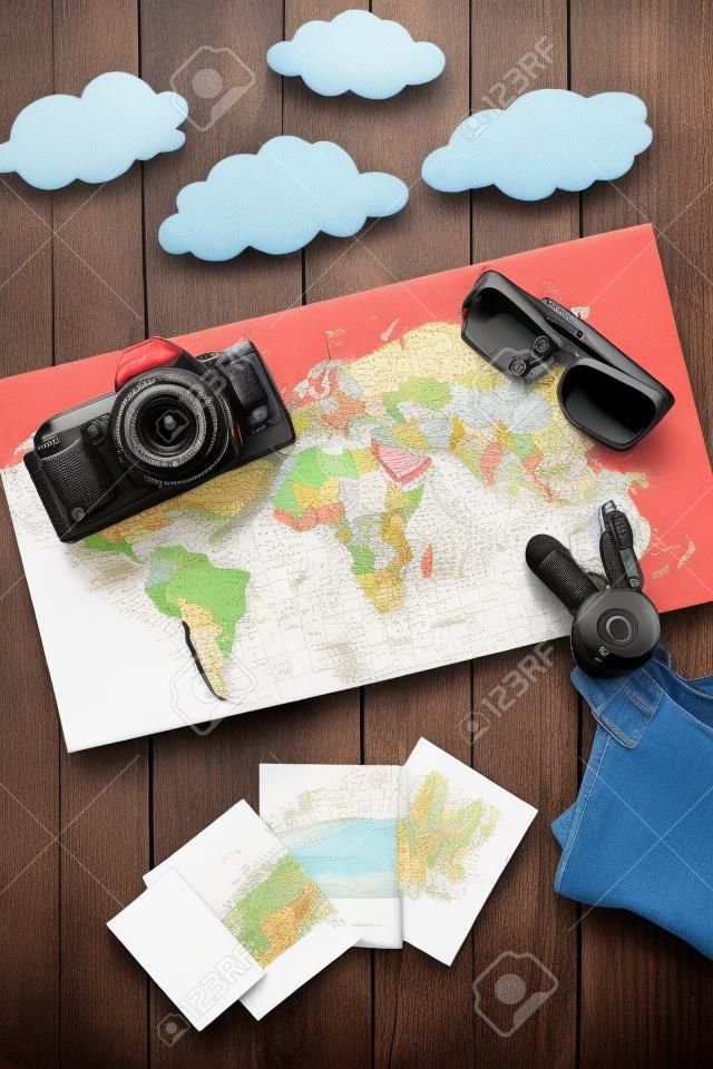 equipo turístico y cámara con mapa para viaje con niños en maqueta de vista superior de fondo de madera oscura
