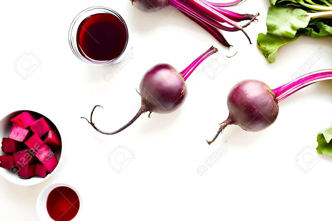 Sliced beet and juice on white table top view copy space