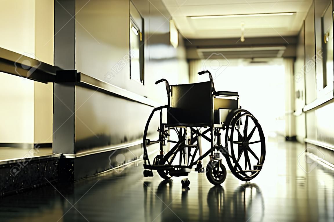 Standard manual wheelchair standing in empty hospital corridor