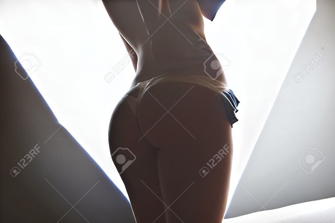 Thin woman taking off panties