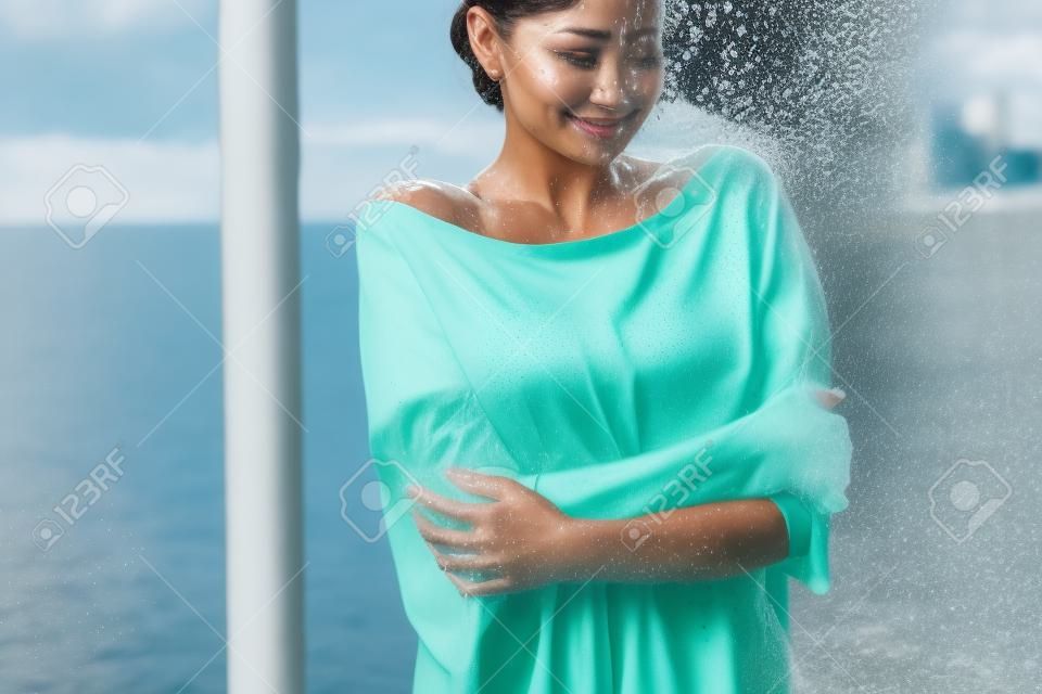 Crop woman in wet blouse avoiding water splash