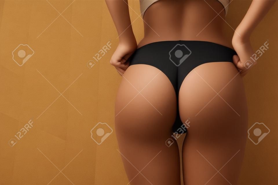 Crop woman with perfect buttocks