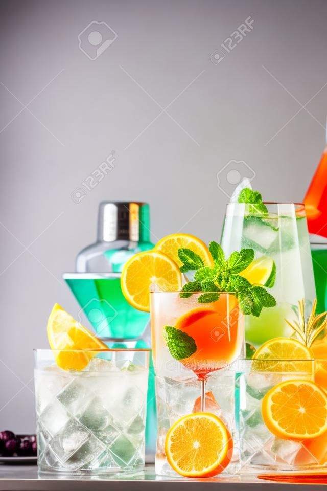Popular trendy cocktails set: aperol spritz, negroni, mojito, gin tonic and cosmopolitan on gray bar counter background