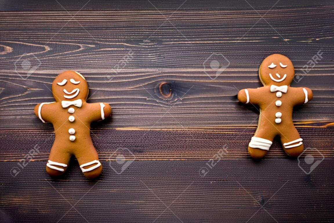 Gingerbread man cookies on wooden background top view.