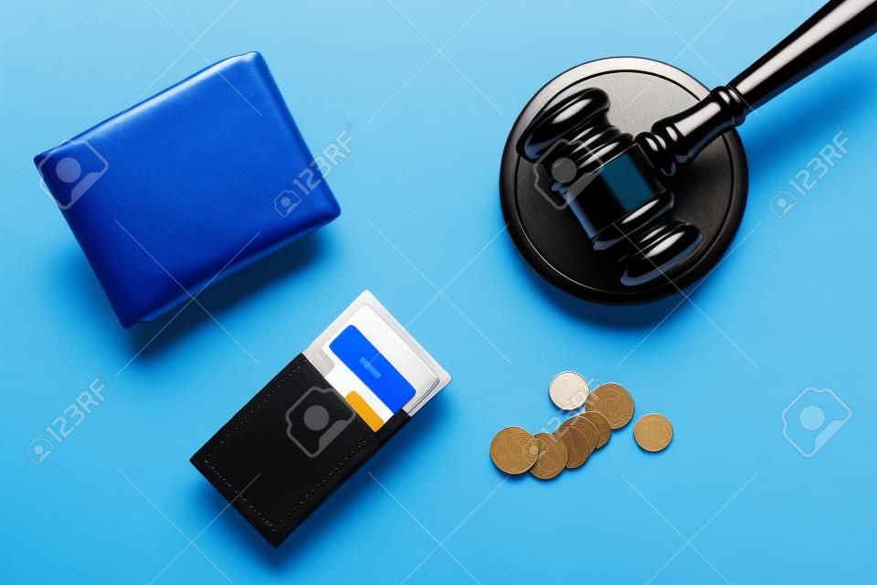 Financial failure, bankruptcy concept. Judge gavel, wallet, coins calculator on blue background