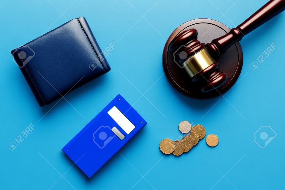 Financial failure, bankruptcy concept. Judge gavel, wallet, coins calculator on blue background