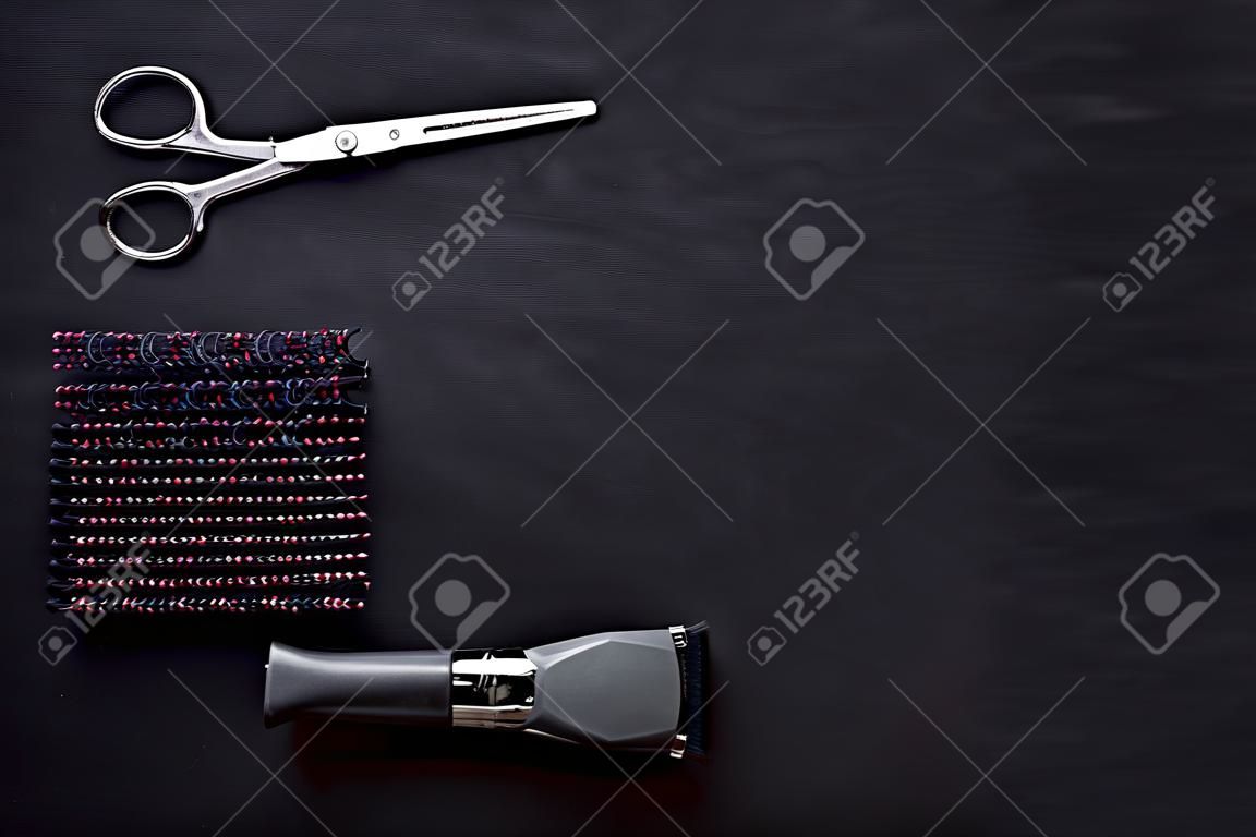 Hairdresser equipment for cutting hair and styling with combs, scissors, brushes on black background top view copyspace