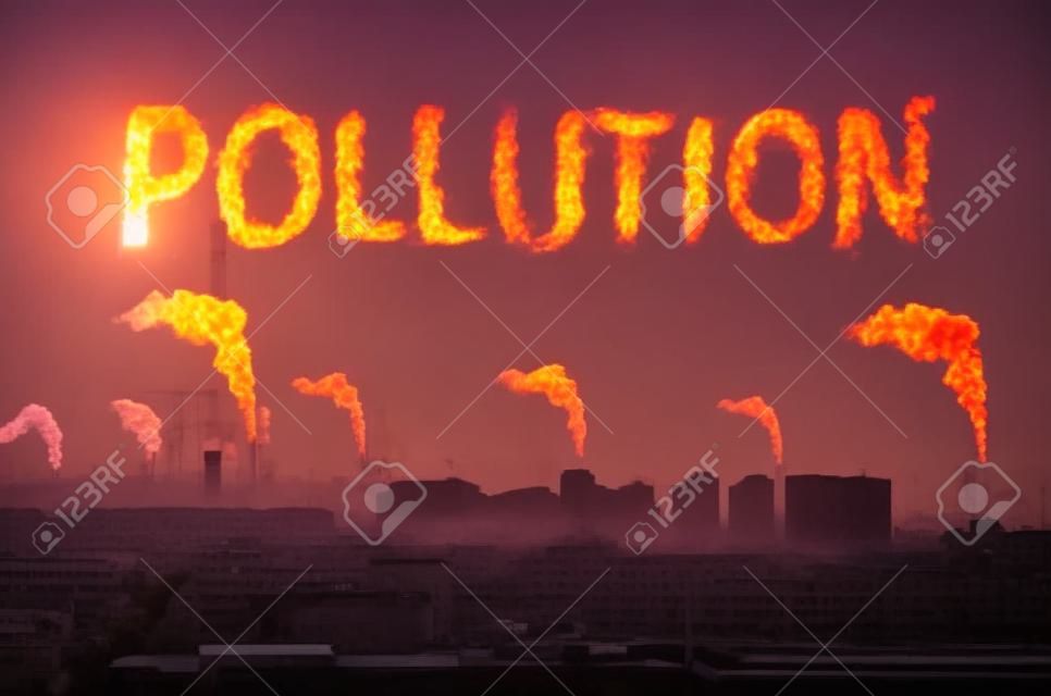Evening view of the industrial landscape of the city with smoke emissions from chimneys at sunset. Inscription pollution