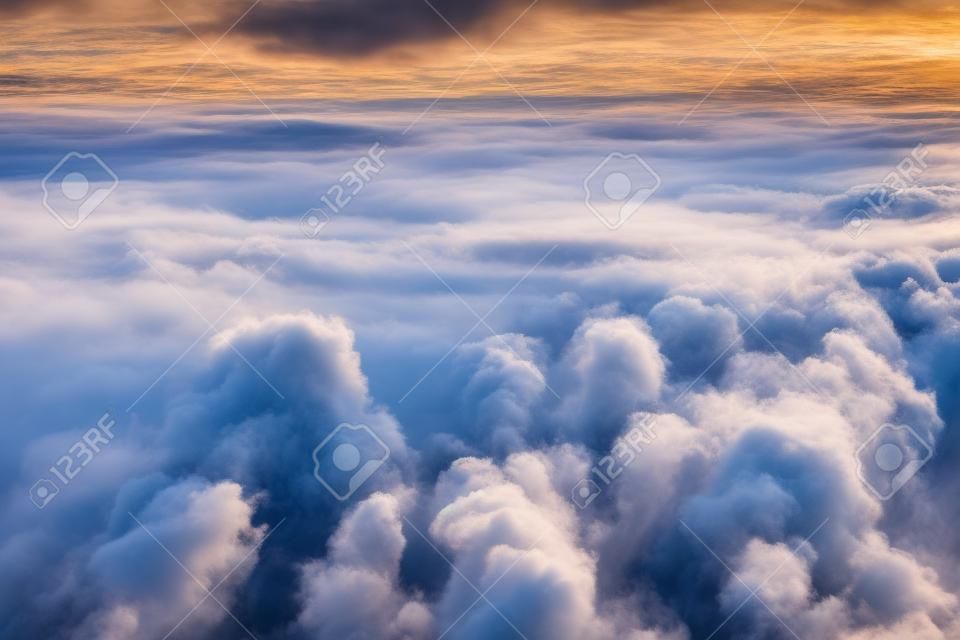 Overcast cloud with height flight level of the airplane, smooth uniform texture of white steam before of the sunset