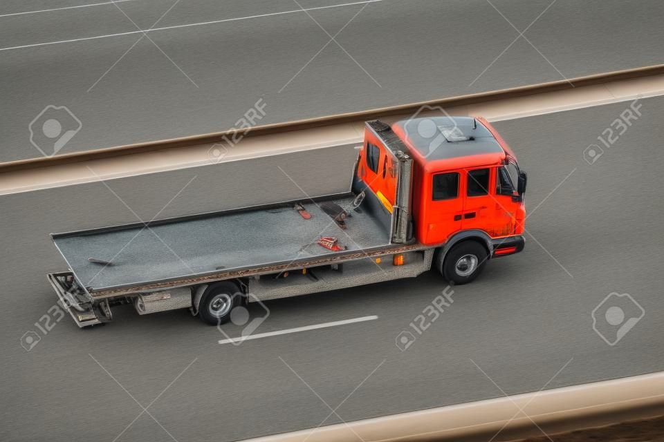 Empty tow truck rides on the highway