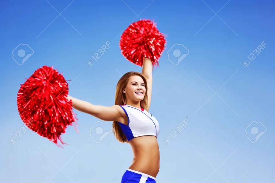 cheerleader girl on a background of blue sky