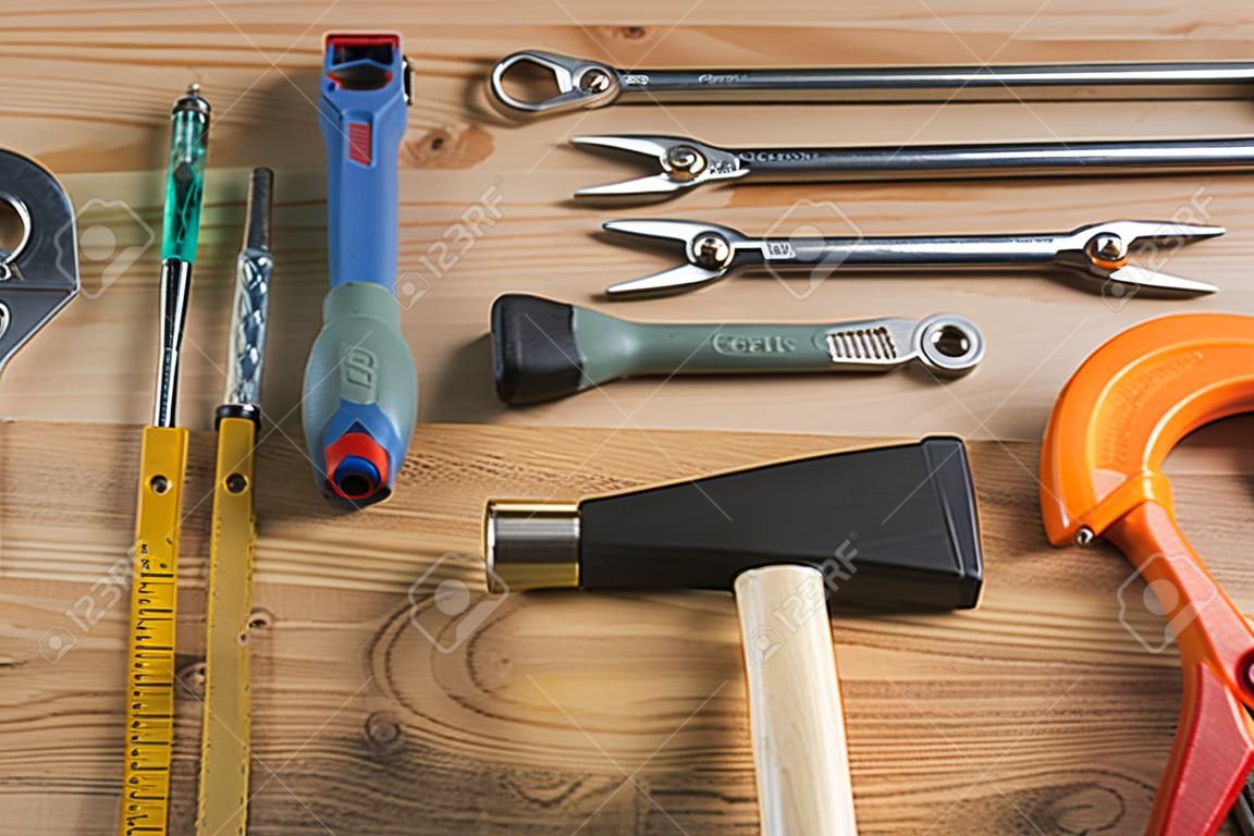Variety of repair tools on wooden surface