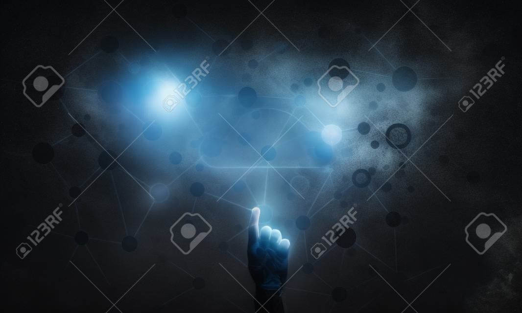 Mans hand pointing to light cloud on dark background