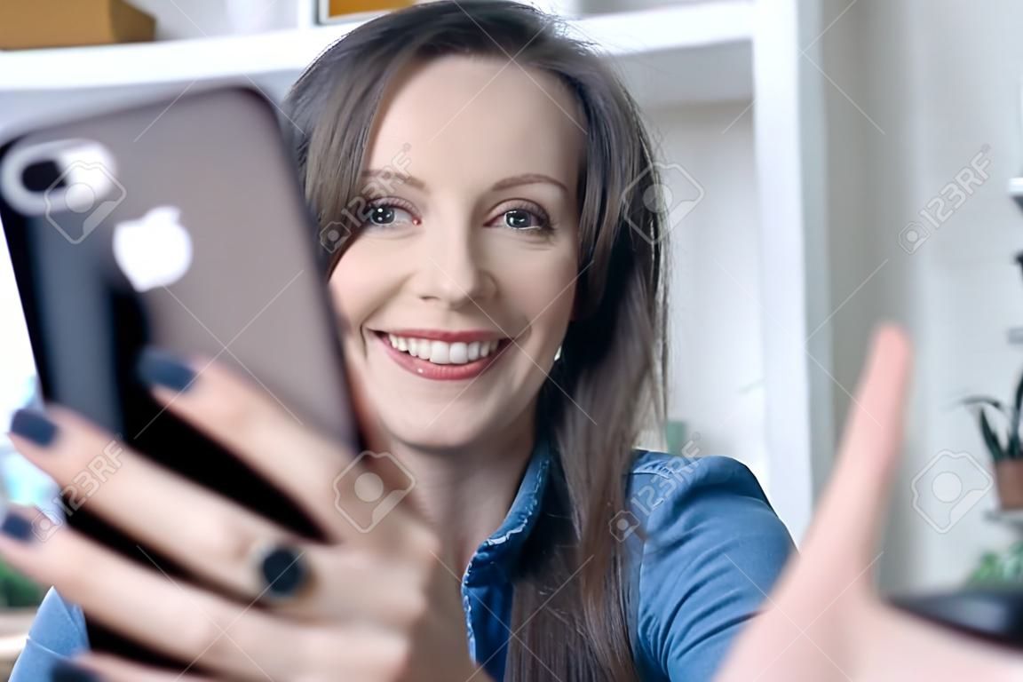 Happy White Woman Smiling, Using Phone, Having Video Call, Video Chatting  At Home Or In The Office. Фотография, картинки, изображения и  сток-фотография без роялти. Image 165862144