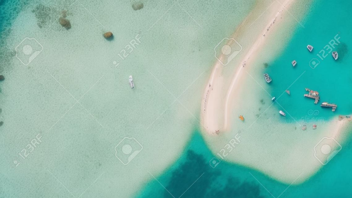 Aerial view or top view of beautiful curve beach with traveller relaxing with the emerald sea at Koh Lipe island in Satun, Thailand. Space for text. - Image