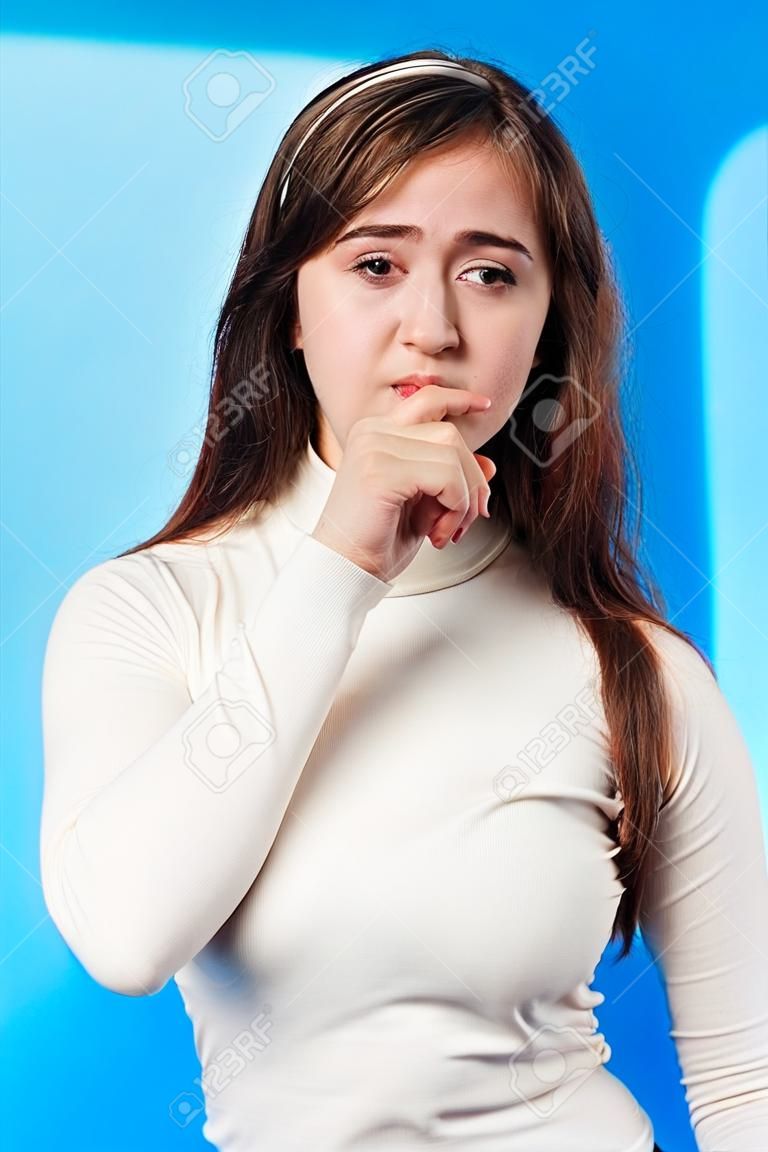 Young beautiful girl isolated on blue background