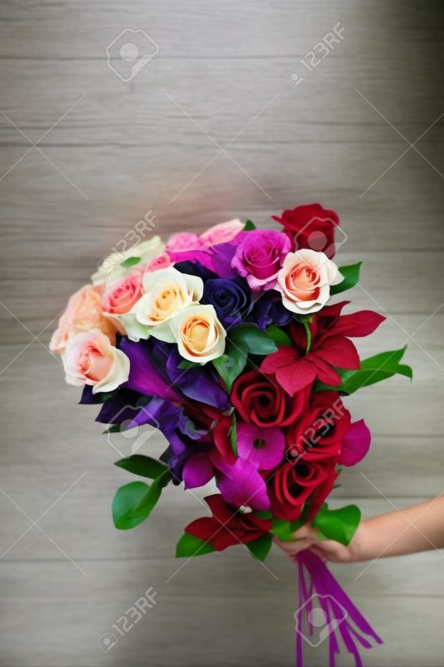 Beautiful bouquet of mixed flowers with roses. The work of the florist. Flower delivery.