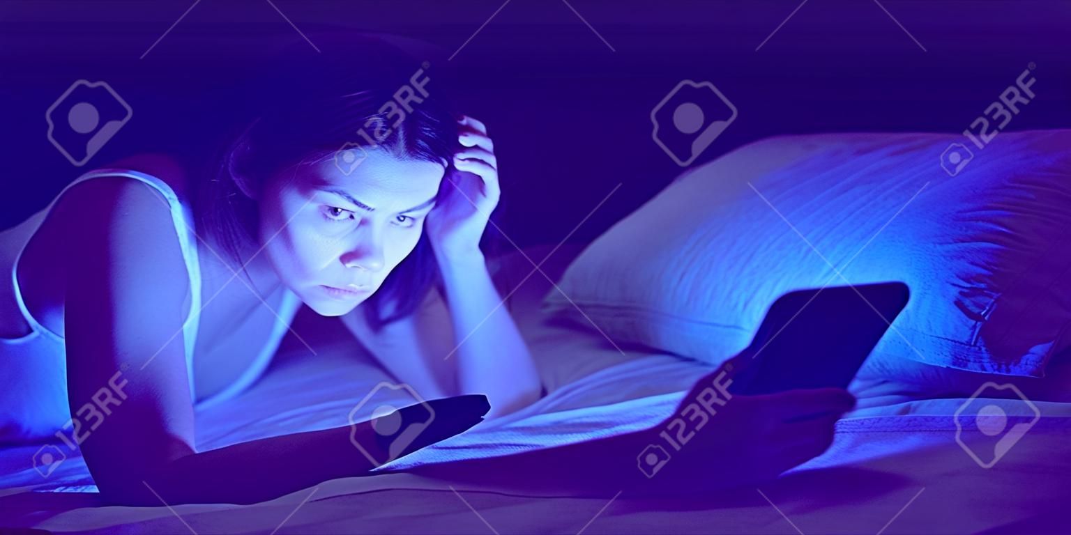 A woman with insomnia is watching a video online on a device.