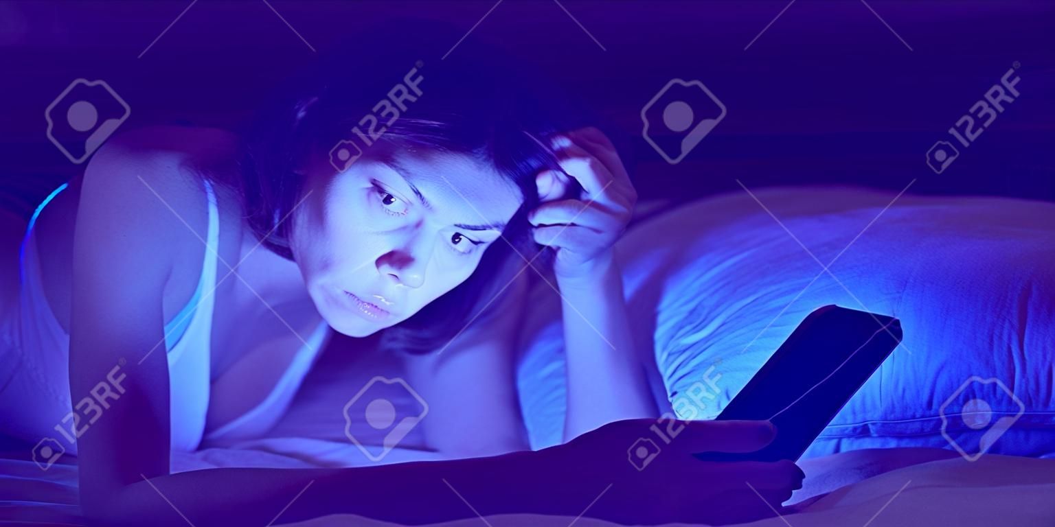 A woman with insomnia is watching a video online on a device.