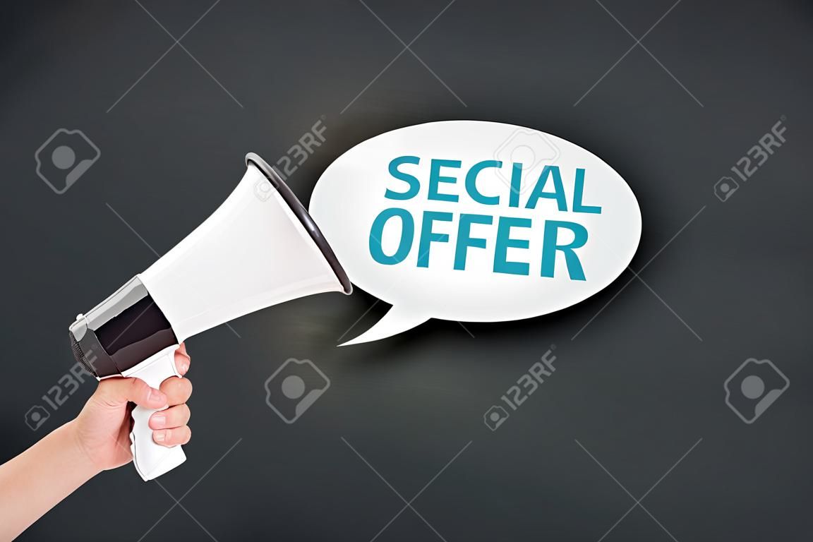Hand holding megaphone agains blackboard with big sale special offer, announcement marketing concept