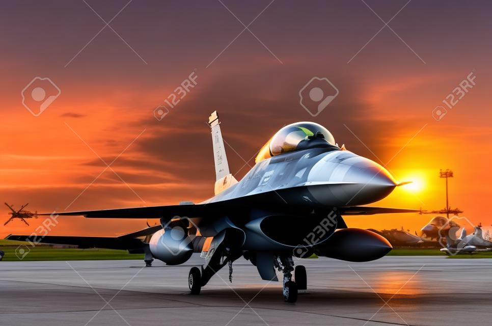 f16 falcon fighter jet parked in the airforce on sunset  background.