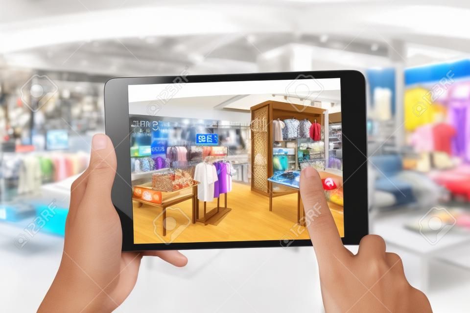 Conceito de marketing de realidade aumentada. Mão segurando tablet digital smartphone usar aplicativo AR para verificar o preço de venda especial no varejo loja de moda shopping