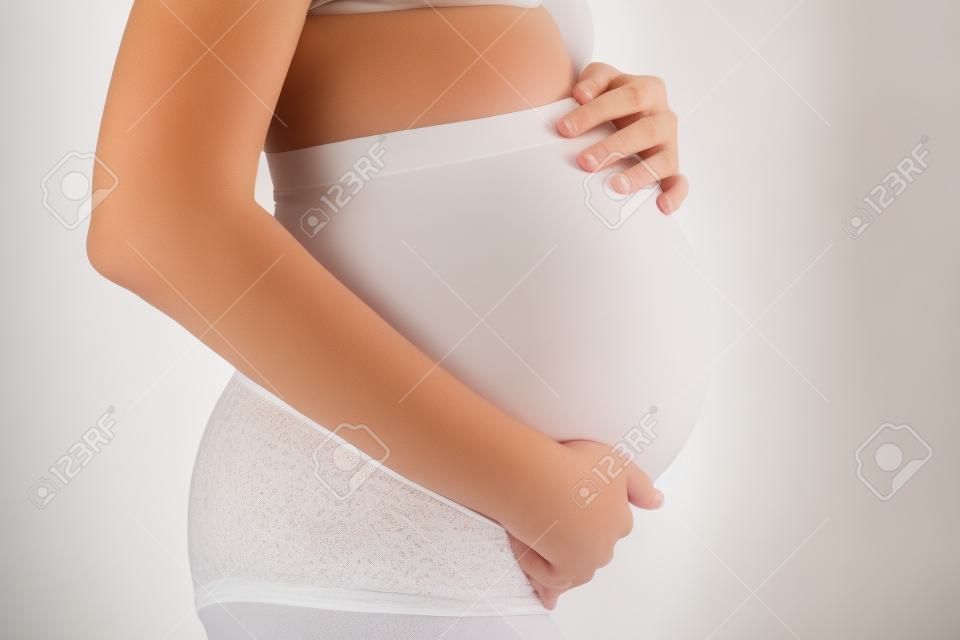 Mujer Embarazada En Ropa Interior Blanca. Joven Mujer Esperando Un Bebé.  Fotos, retratos, imágenes y fotografía de archivo libres de derecho. Image  68662788
