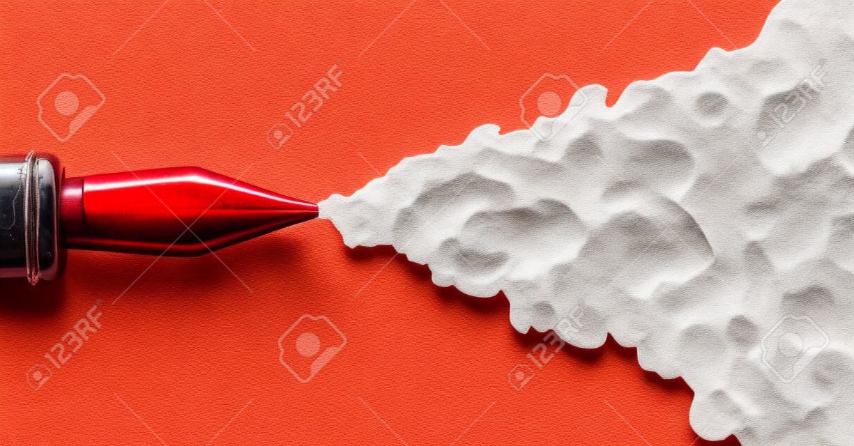 一个旧钢笔的金属笔尖的顶部，在一个孤立的白色背景下喷出一股厚厚的红墨水。