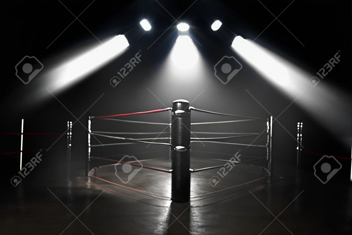 A concept showing a boxing ring on a reflective concrete pitch with illuminated red lines backlit by a single honeycomb spotlight - 3D render