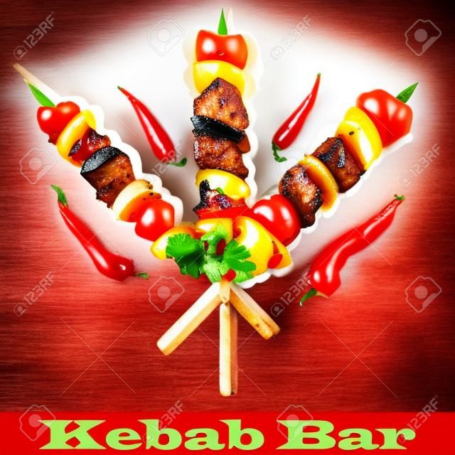 Shish kebab with onion and cherry tomato. Grilled meat skewers.