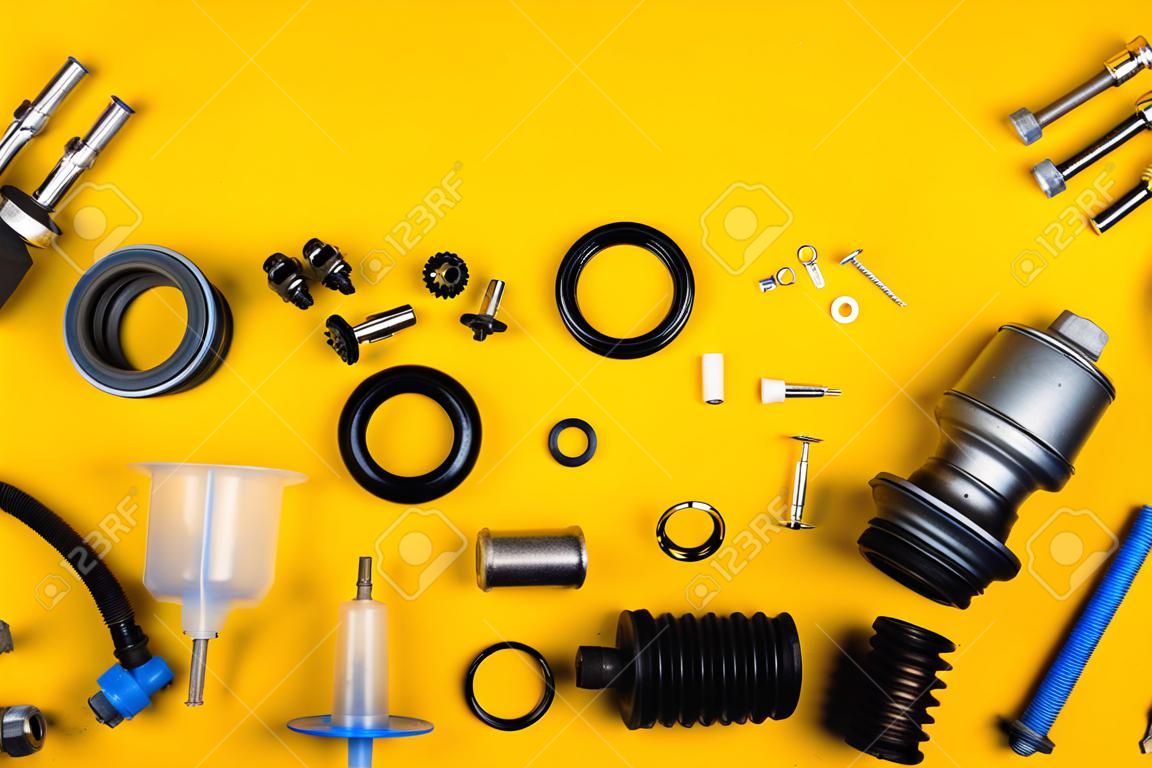 Set of car parts for maintenance on yellow background
