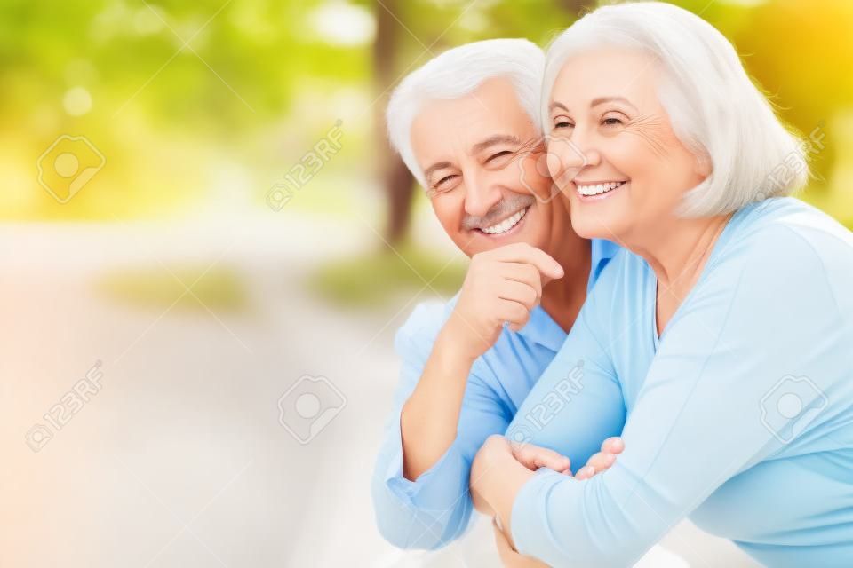 Happy mature couple in a spring park