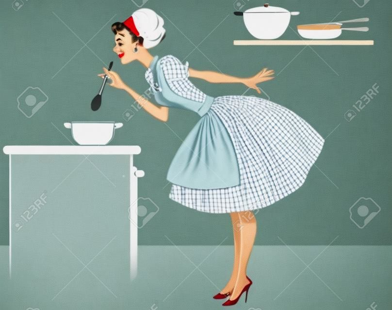 1950 年代のかわいい服彼女のキッチンで調理の女