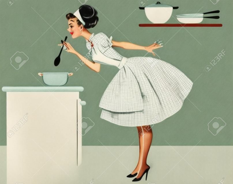 女人在一个可爱的1950年代装在厨房做饭