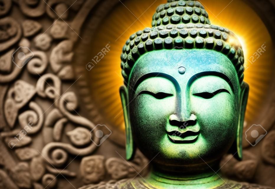 Rock Buddha statue with sunlight used for amulets of Buddhism religion. Buddhism is popular region in China Japan and south east Asia.copy space concept.