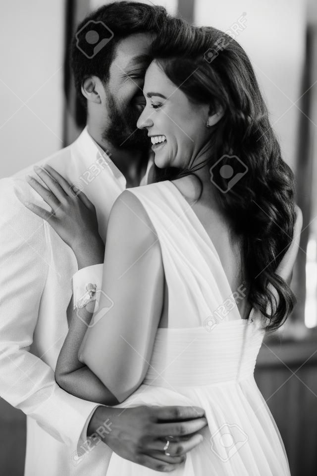 Black and white photo of happy young couple in love hugging each other. high quality photo