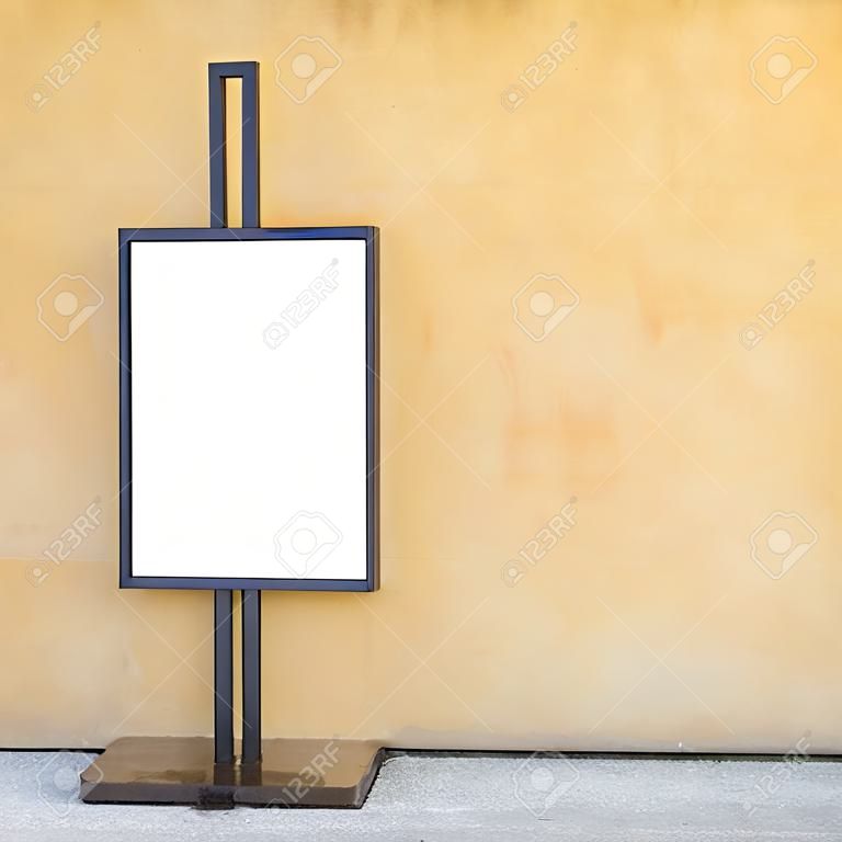 Blank billboard against yellow concrete wall