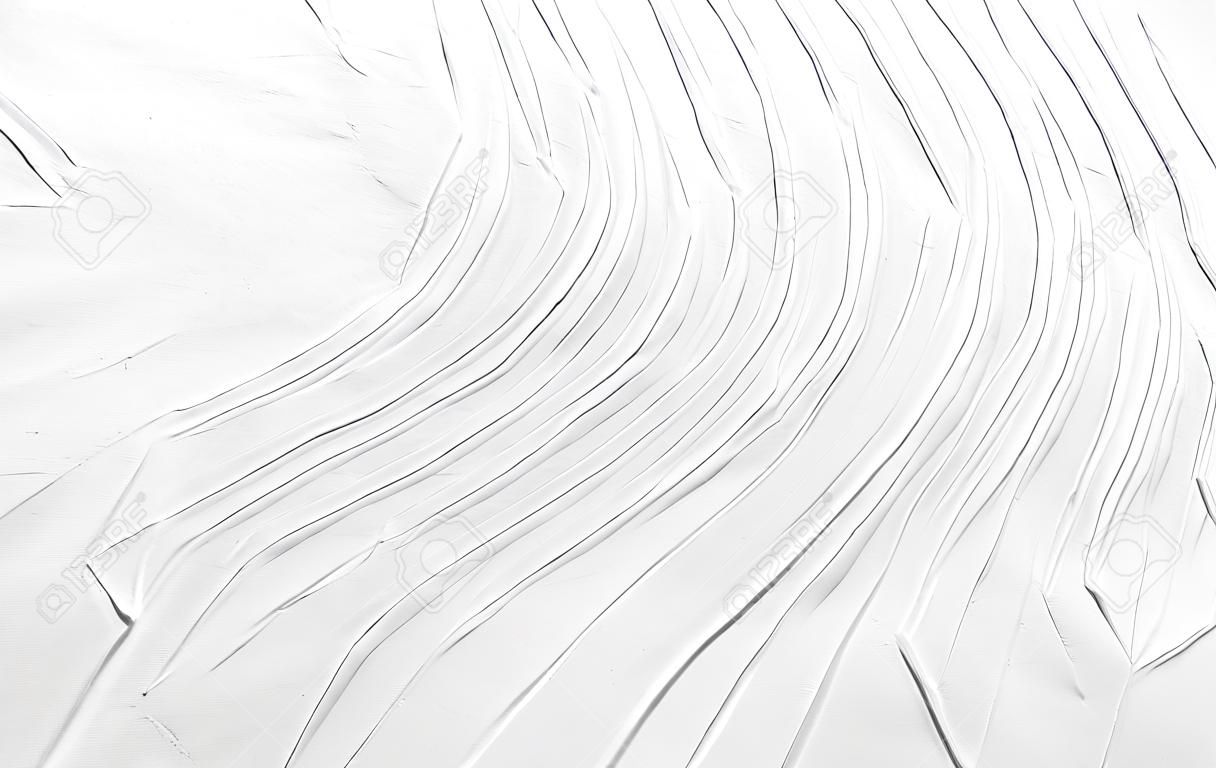 Sfondo astratto bianco con una superficie ruvida di linee ondulate. Struttura di gesso, cemento