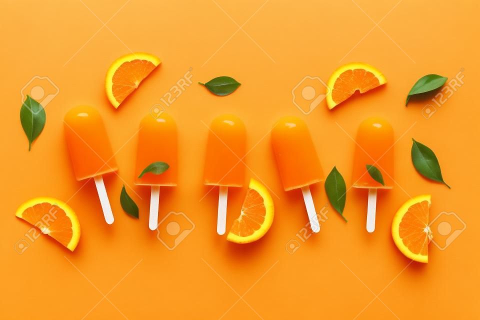 Orange with juice. Ice pops, flat lay, top view