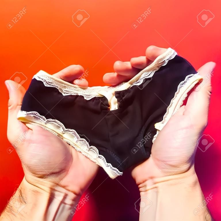 Hands holding underwear