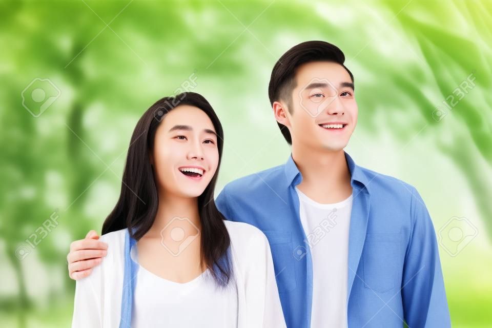 Portrait of young Chinese couple standing smiling outdoor