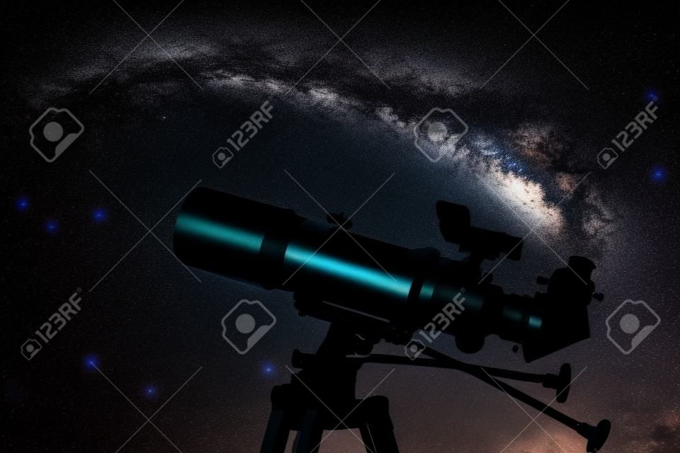 Silhouette of Telescope in real night sky. Blurred night sky. Blurred milky way. Refractor type telescope