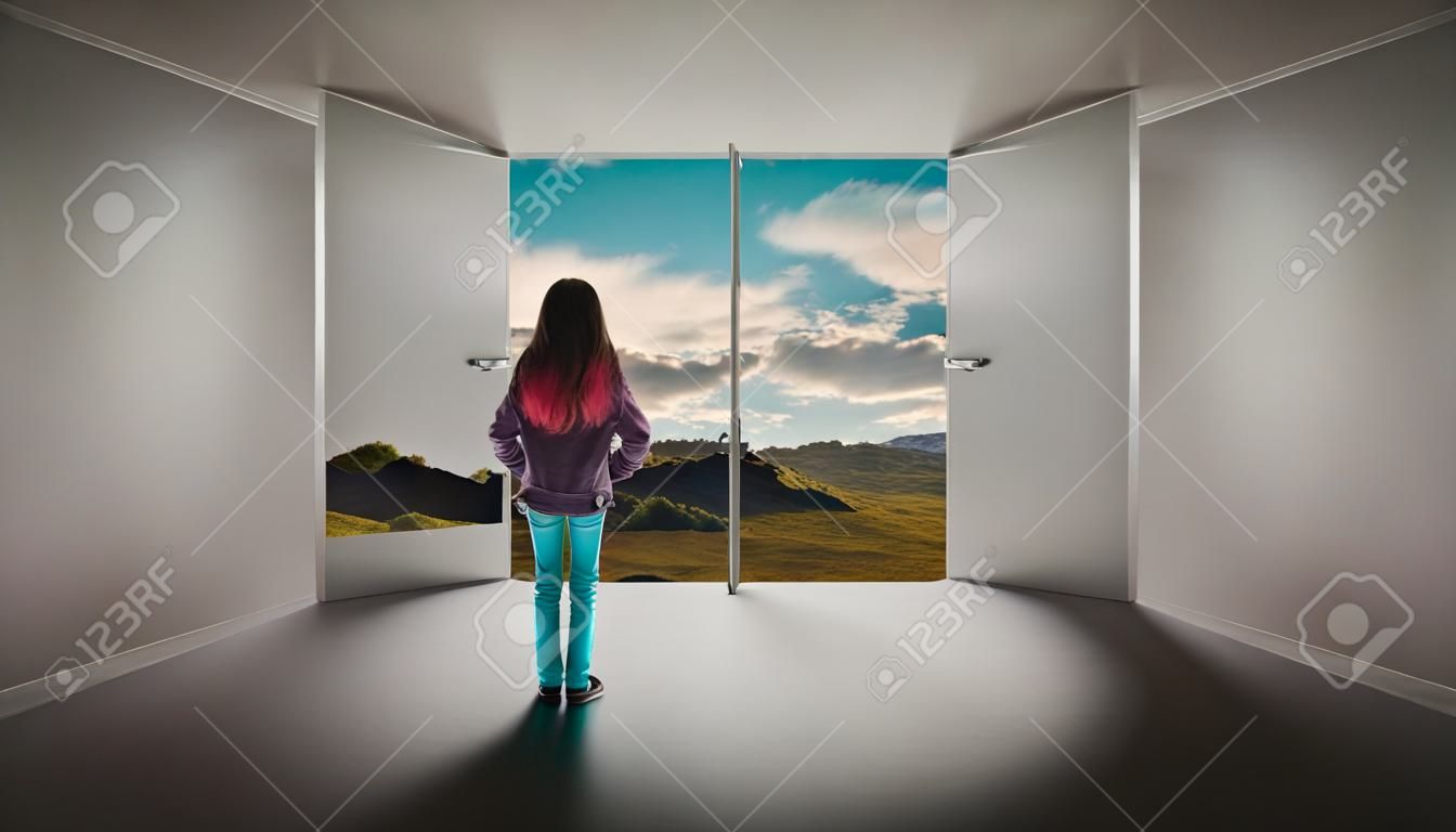 Young girl standing in a room with a door opened leading to a beautiful landscape. The concept of escape.