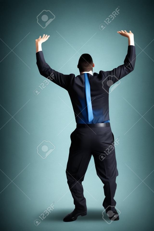 Business man holding something heavy above head